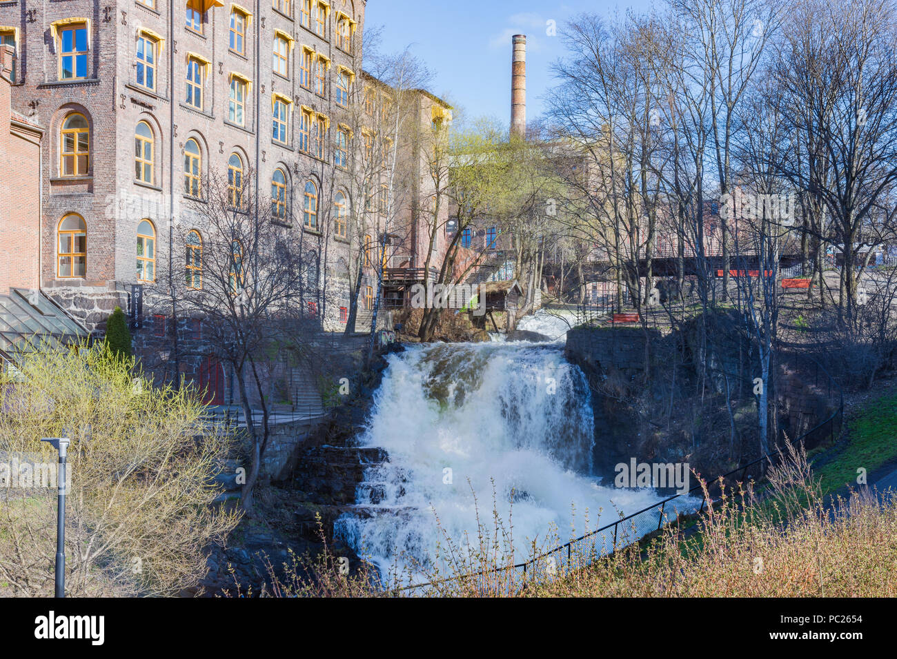 The largest waterfall of the Akerselva River in Oslo is the one near the cottage known as `Hønse-Lovisas hus`, a small red house near the Beier bridge Stock Photo